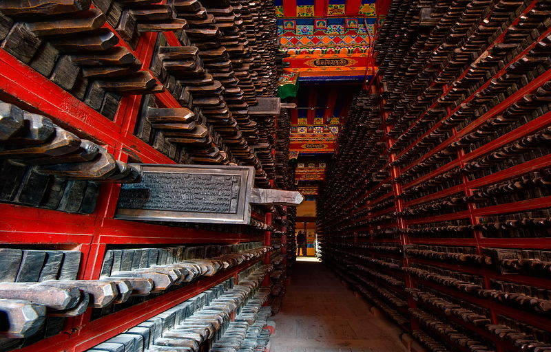 Dege Scripture Printing House, Dege, Sichuan, China - the library of carved wooden printing blocks. One floor of the library is taken up with the collection of woodblock sutras, stacked in shelves with their handles facing outwards. The official number of the collection is 270,000. The blocks are in three editions according to size, the longest being the ‘arrow-stick’ (60-70cm, the length of an arrow).
